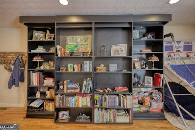interior space with visible vents and wood finished floors