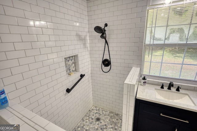 bathroom with vanity and tiled shower