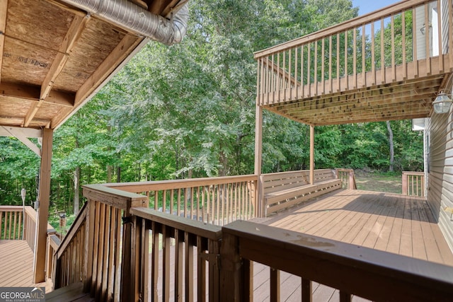 wooden deck with a wooded view