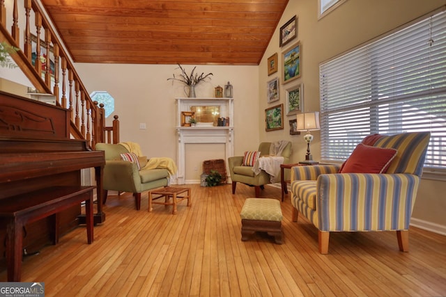 living area featuring stairs, wood-type flooring, wooden ceiling, high vaulted ceiling, and baseboards