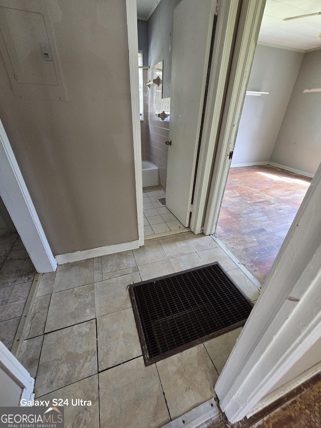 bathroom with baseboards and tile patterned flooring