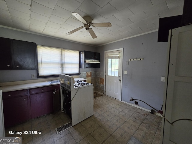 kitchen featuring visible vents, light countertops, ornamental molding, and a ceiling fan