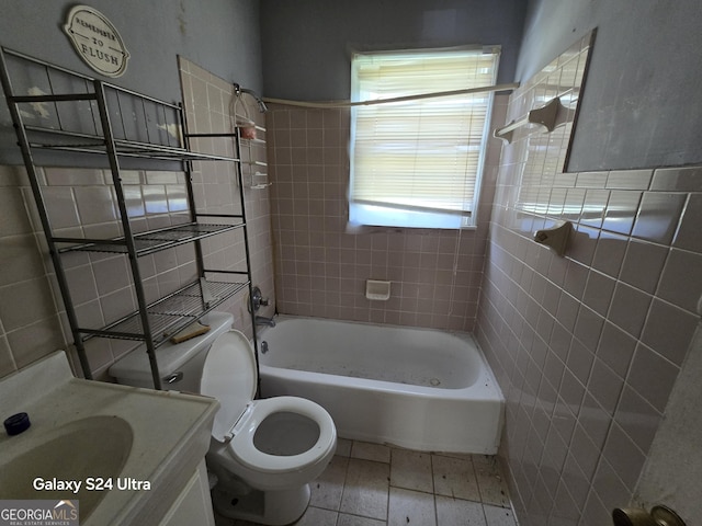 bathroom featuring toilet, vanity, and shower / washtub combination