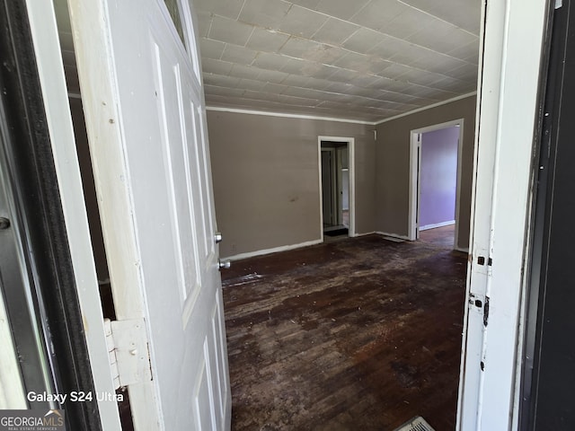 interior space featuring dark wood-type flooring and baseboards