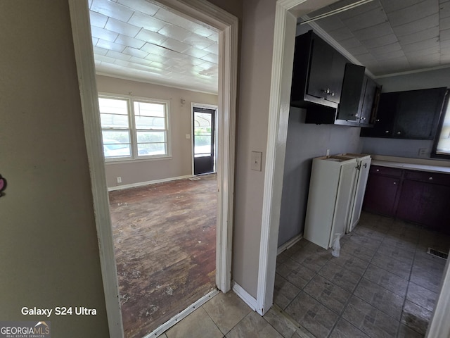 kitchen featuring ornamental molding, baseboards, and visible vents