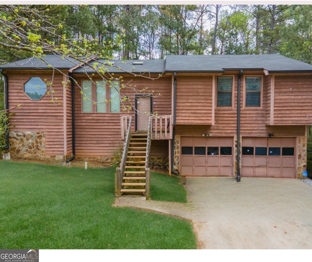 4020 Cranwood Dr, Atlanta, GA 30349 - view of front of house featuring a front yard, stone siding, a garage, stairway, and driveway
