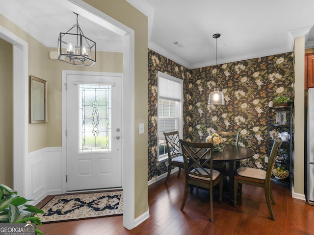 717 Bay Skipper Ct, Griffin, GA 30223 - dining area with wallpapered walls, crown molding, a chandelier, and dark wood-type flooring