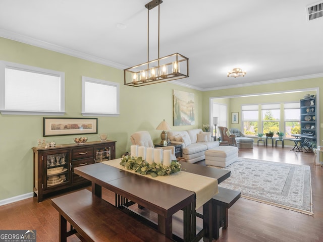 717 Bay Skipper Ct, Griffin, GA 30223 - dining room with crown molding, wood finished floors, and a chandelier
