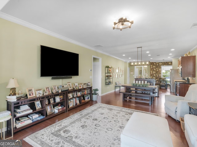 717 Bay Skipper Ct, Griffin, GA 30223 - living area with ornamental molding, dark wood finished floors, a chandelier, and recessed lighting