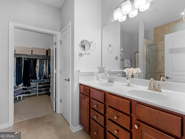 717 Bay Skipper Ct, Griffin, GA 30223 - bathroom with a stall shower, double vanity, a spacious closet, and tile patterned floors
