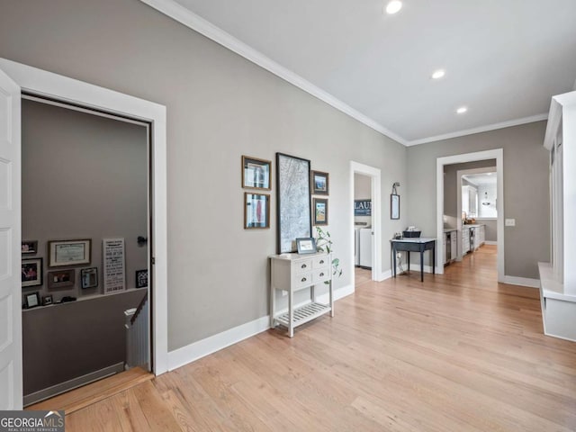 corridor featuring recessed lighting, crown molding, light wood-style floors, and baseboards
