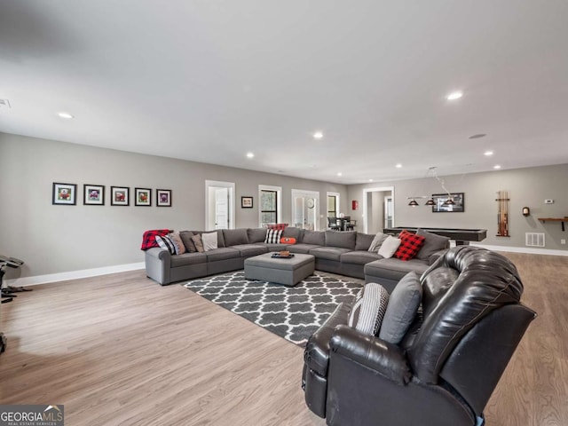living room with wood finished floors, recessed lighting, baseboards, and visible vents