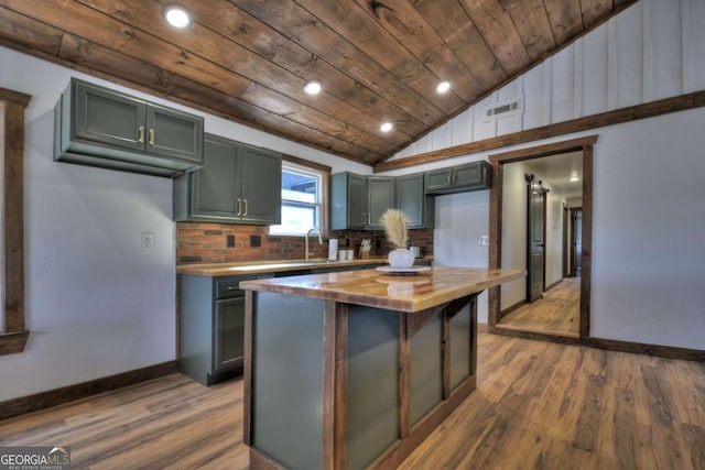 kitchen with dark wood finished floors, wood ceiling, lofted ceiling, wood counters, and decorative backsplash