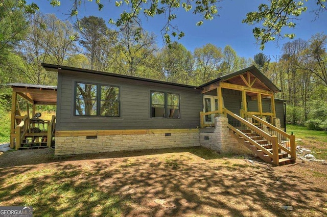 view of front facade with crawl space and stairs