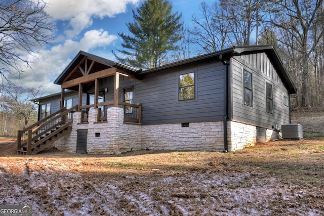 view of front facade with cooling unit and stone siding