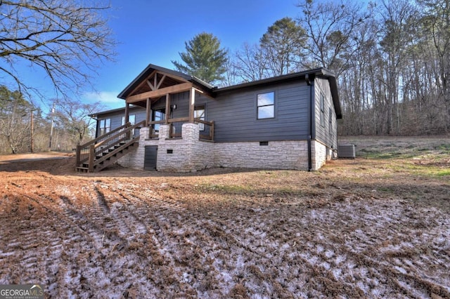 view of front facade featuring central air condition unit and crawl space