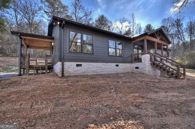 view of front of home featuring stairway and crawl space