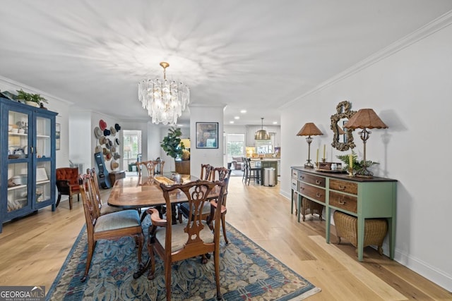 living area featuring ceiling fan, wood finished floors, healthy amount of natural light, and a stone fireplace