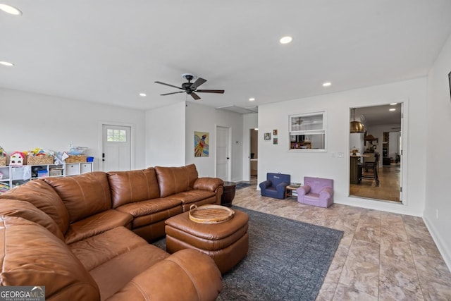 bedroom featuring light wood-style flooring, baseboards, connected bathroom, and a ceiling fan
