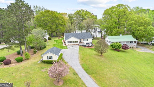 rear view of house with a wooden deck and a yard