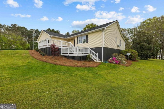 wooden deck with a lawn and view of wooded area