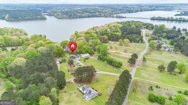 aerial view of property and surrounding area featuring a nearby body of water