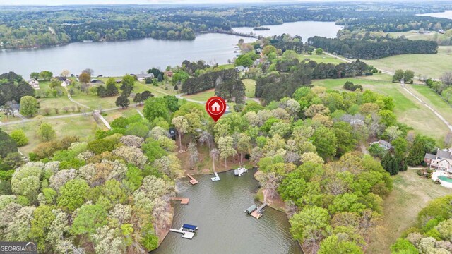 bird's eye view of a nearby body of water and a heavily wooded area