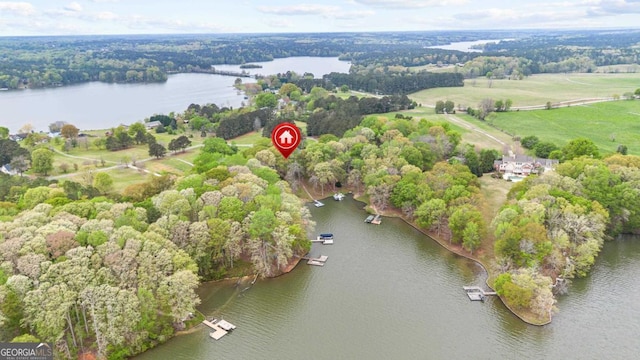 view of property location featuring a large body of water and a forest