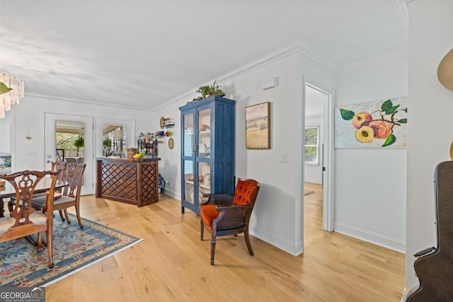 entryway featuring ornamental molding and light wood-type flooring