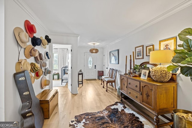 dining area with light wood-type flooring, a chandelier, and crown molding
