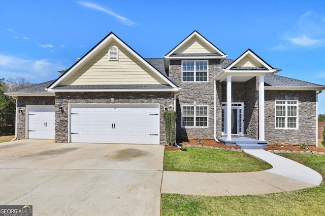view of front of home with a garage, stone siding, and driveway