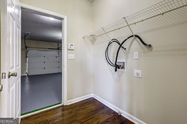 clothes washing area featuring washer hookup, dark wood finished floors, baseboards, and laundry area