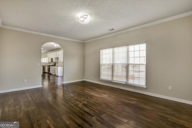 6793 Oconee Pl, Fairburn, GA 30213 - empty room with arched walkways, crown molding, dark wood finished floors, and a textured ceiling