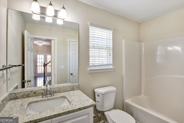 6793 Oconee Pl, Fairburn, GA 30213 - bathroom featuring vanity, bathing tub / shower combination, and a textured ceiling