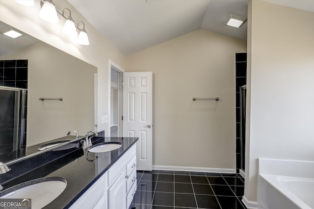 bathroom with a sink, vaulted ceiling, and a stall shower