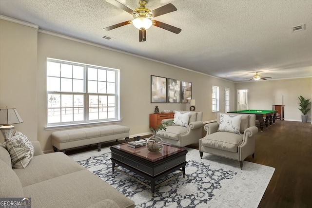 living area featuring wood finished floors, a ceiling fan, a textured ceiling, visible vents, and pool table
