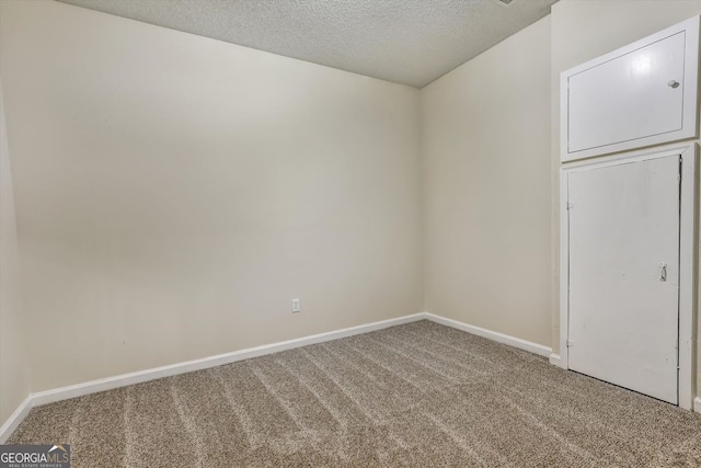 unfurnished bedroom featuring baseboards, a textured ceiling, and carpet floors