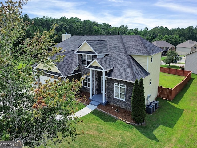6793 Oconee Pl, Fairburn, GA 30213 - view of front of house featuring roof with shingles, stone siding, and a chimney