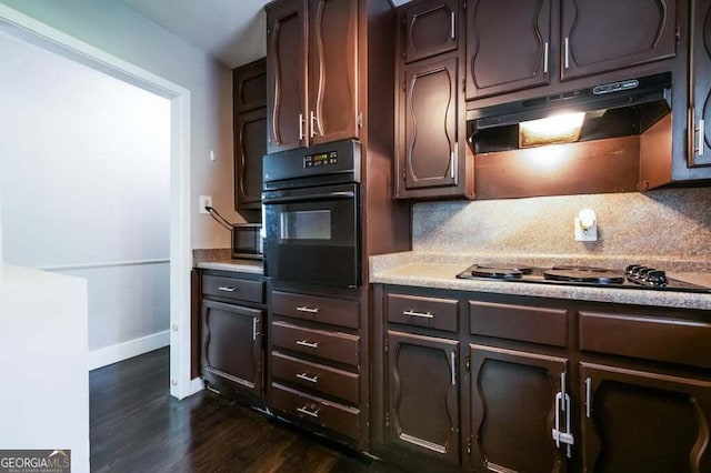 3614 Fairburn Pl NW, Atlanta, GA 30331 - kitchen with light countertops, dark wood-style floors, under cabinet range hood, baseboards, and black appliances