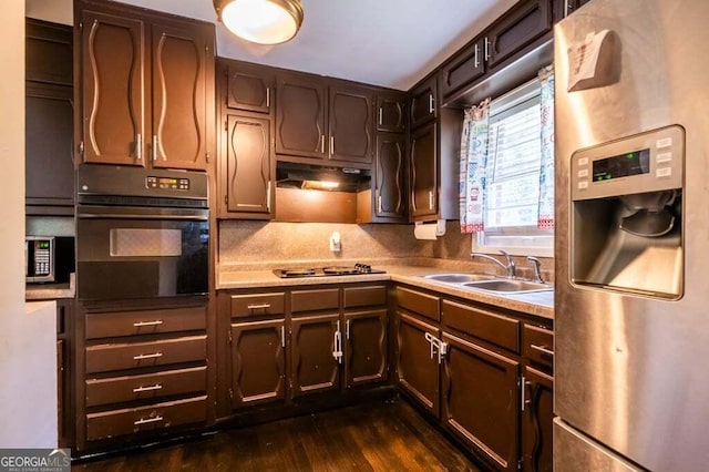 3614 Fairburn Pl NW, Atlanta, GA 30331 - kitchen with cooktop, a sink, stainless steel fridge with ice dispenser, under cabinet range hood, and black oven