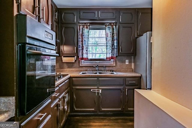 3614 Fairburn Pl NW, Atlanta, GA 30331 - kitchen featuring light countertops, backsplash, a sink, black appliances, and dark wood-style flooring