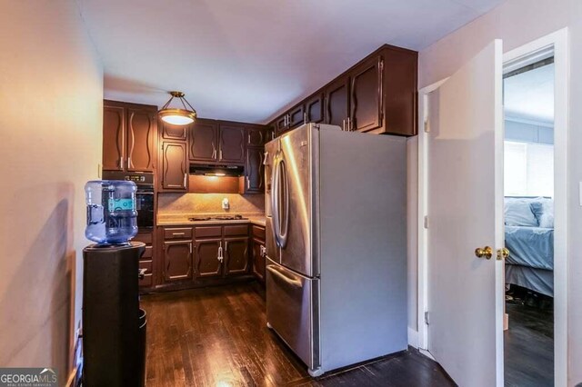 3614 Fairburn Pl NW, Atlanta, GA 30331 - kitchen with light countertops, stainless steel appliances, dark wood-type flooring, under cabinet range hood, and dark brown cabinetry