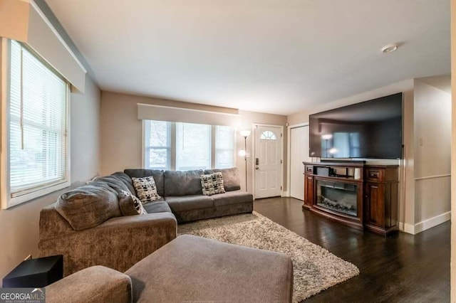 3614 Fairburn Pl NW, Atlanta, GA 30331 - living room featuring dark wood-type flooring, baseboards, a glass covered fireplace, and a healthy amount of sunlight