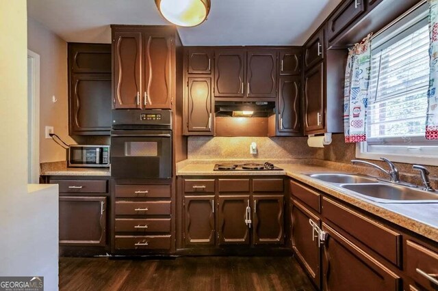 3614 Fairburn Pl NW, Atlanta, GA 30331 - kitchen featuring oven, stainless steel microwave, under cabinet range hood, a sink, and gas stovetop