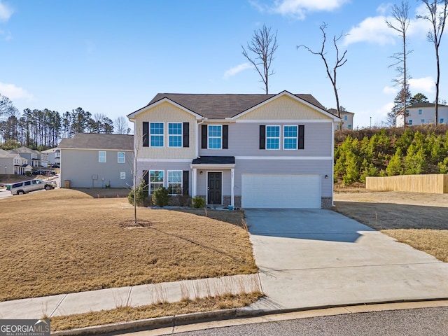 traditional home with driveway, fence, stone siding, and a garage