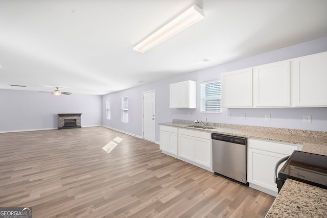 kitchen featuring dishwasher, a sink, a ceiling fan, black / electric stove, and light wood finished floors