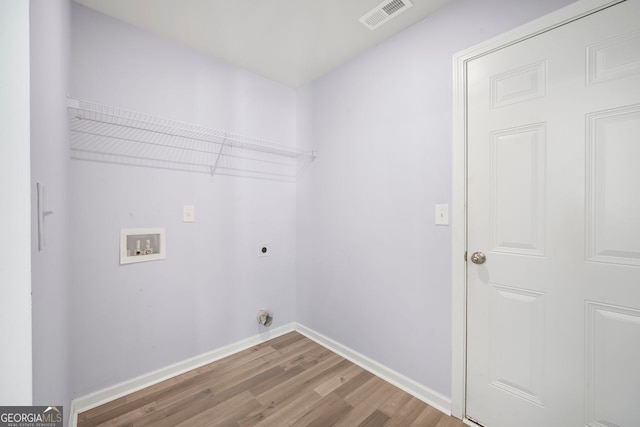 laundry room featuring laundry area, electric dryer hookup, visible vents, wood finished floors, and washer hookup