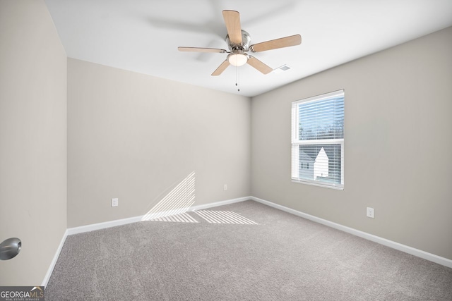 spare room featuring visible vents, ceiling fan, baseboards, and carpet