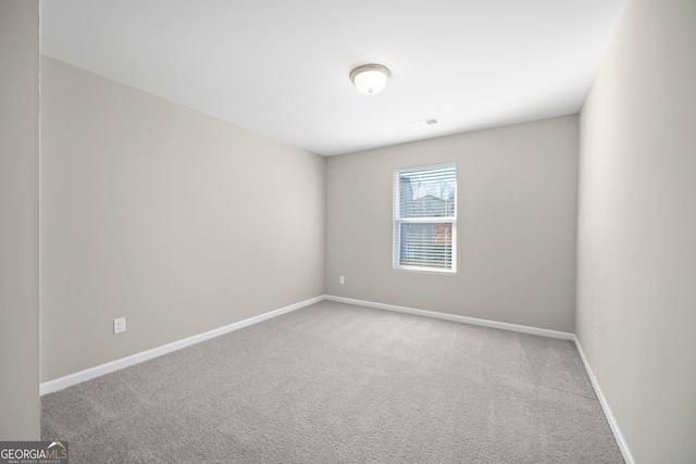 empty room with carpet floors and baseboards