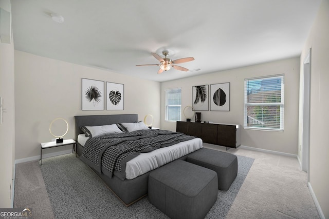 carpeted bedroom with visible vents, baseboards, and ceiling fan